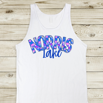 White tank top with 'NORRIS LAKE' printed in colorful letters on a wooden surface